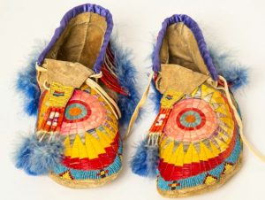 An elaborately decorated pair of Native American shoes.